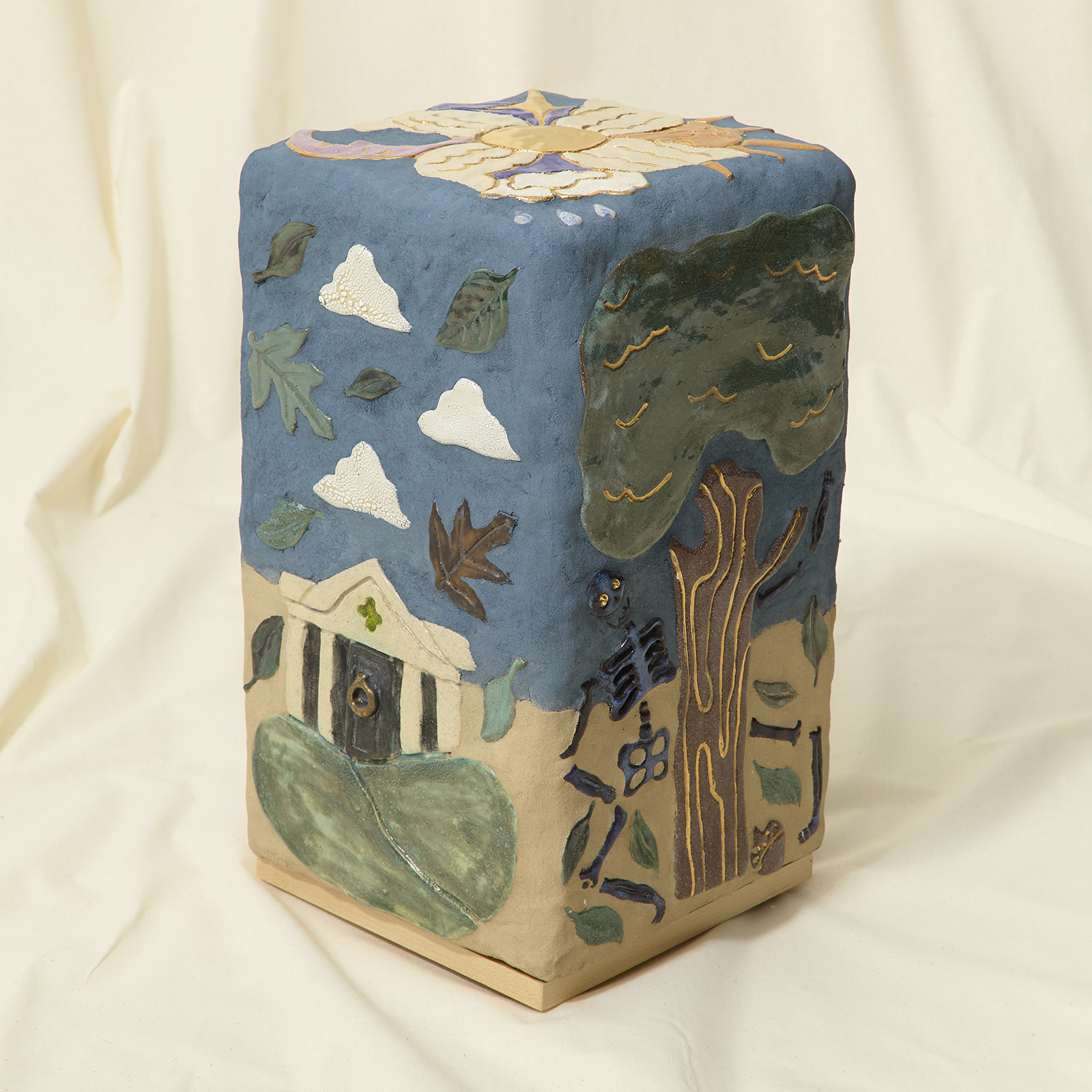 ceramic side table with figurative tiles depicting scenes of a cemetery with a grave, an obelisk, a skeleton under a tree and flowers