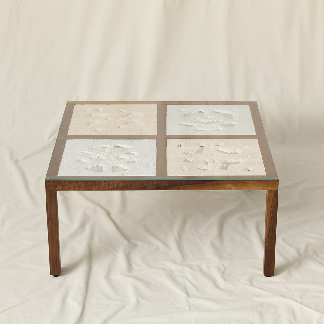 Coffee Table made of walnut wood frame with marble and travertine inserts on the surface that are sandblasted into the shape of a walnut nut cross-section