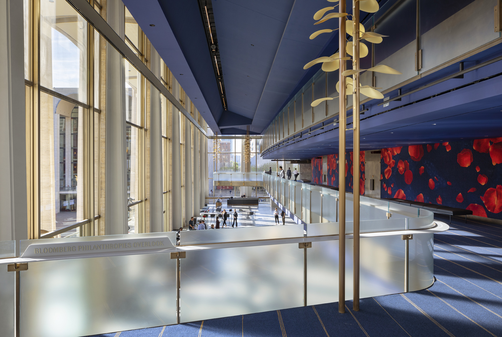 interior of david geffen hall with tall lighting installation consisting of gold tone petals