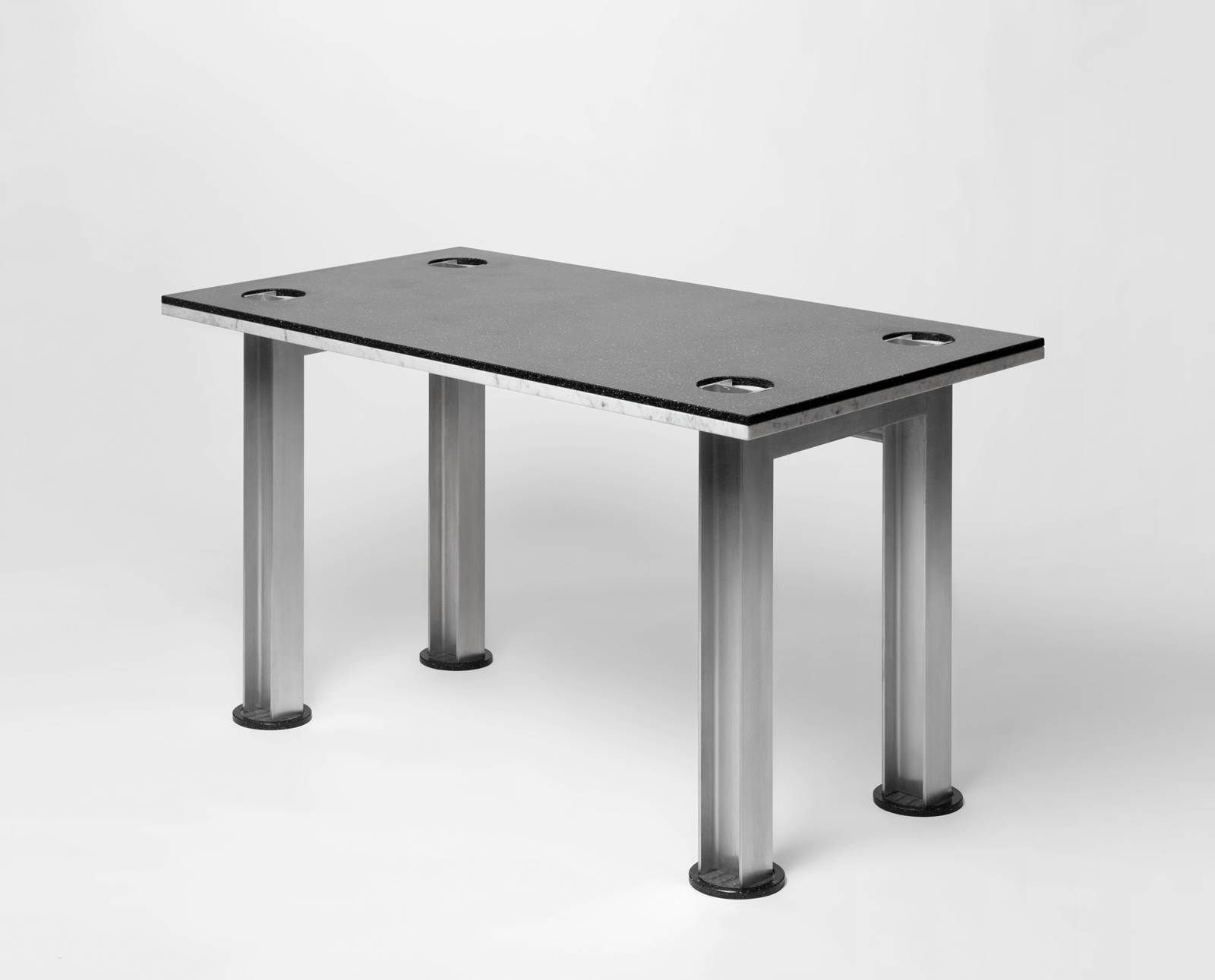 black speckled Corian table top with aluminum I-beam base.