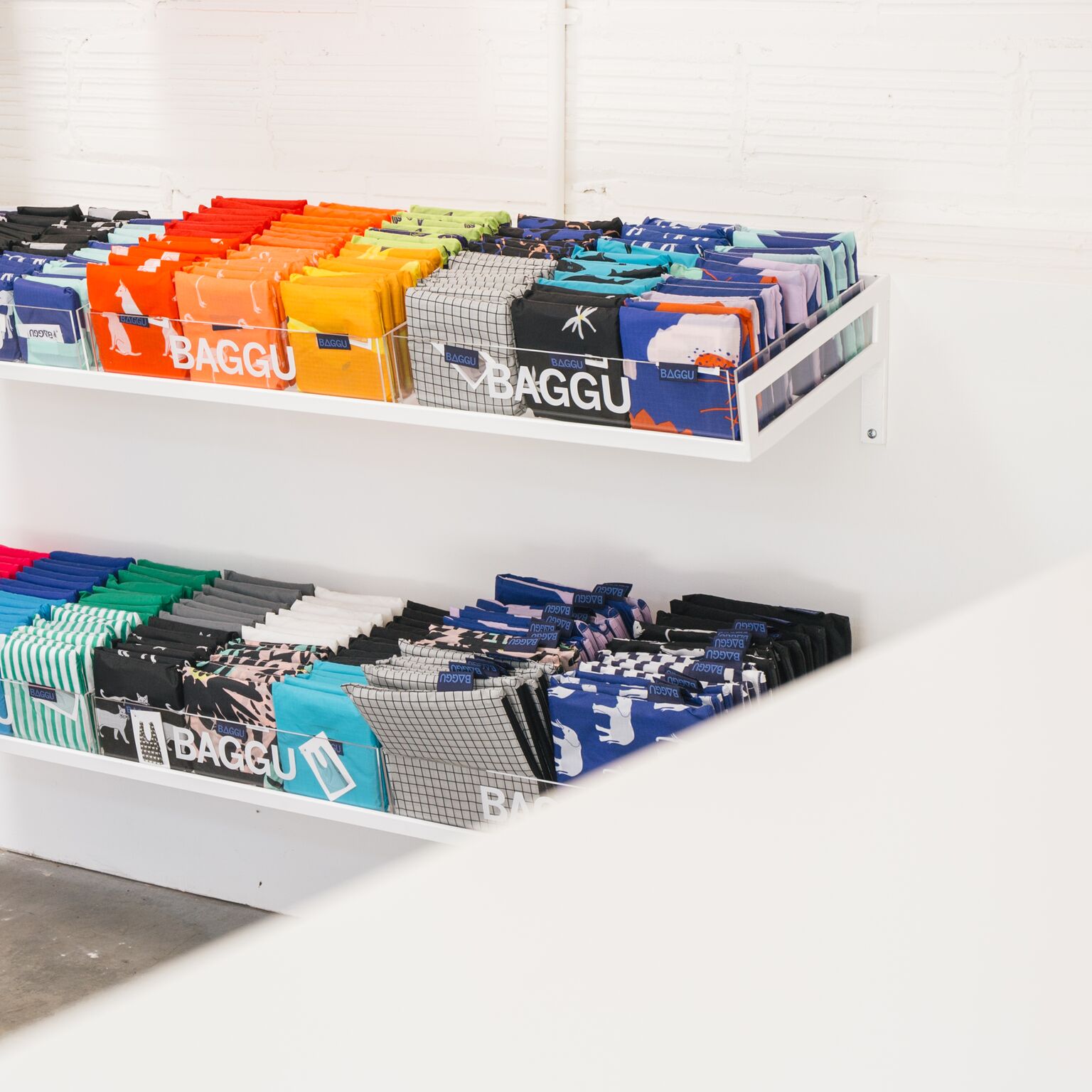 shelves of folded colorful bags.