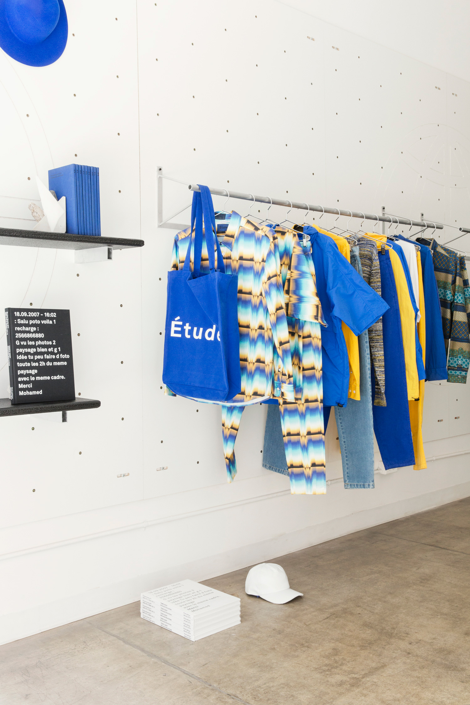 colorful clothing racks in a white room.