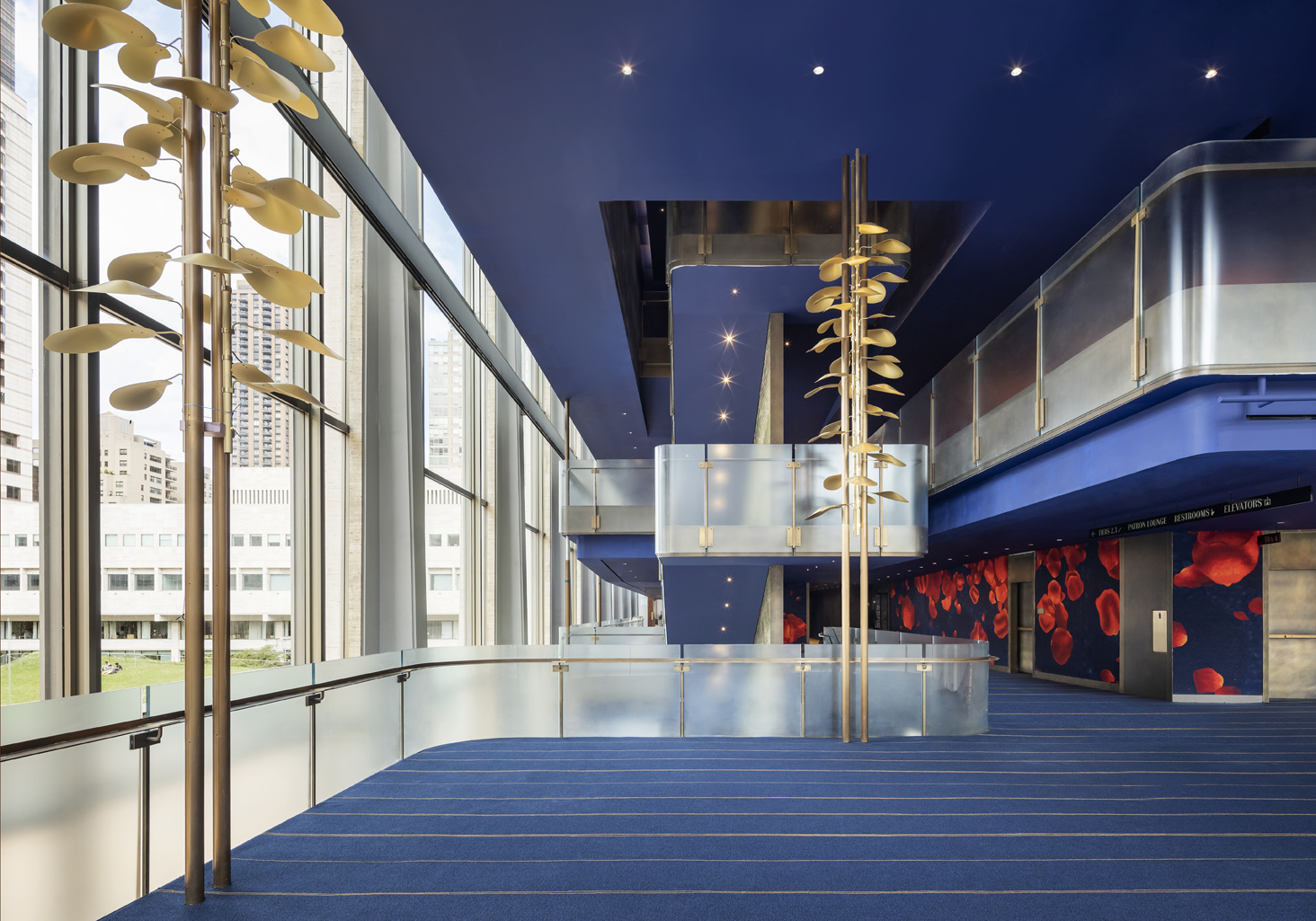 interior of david geffen hall with tall lighting installation consisting of gold tone petals