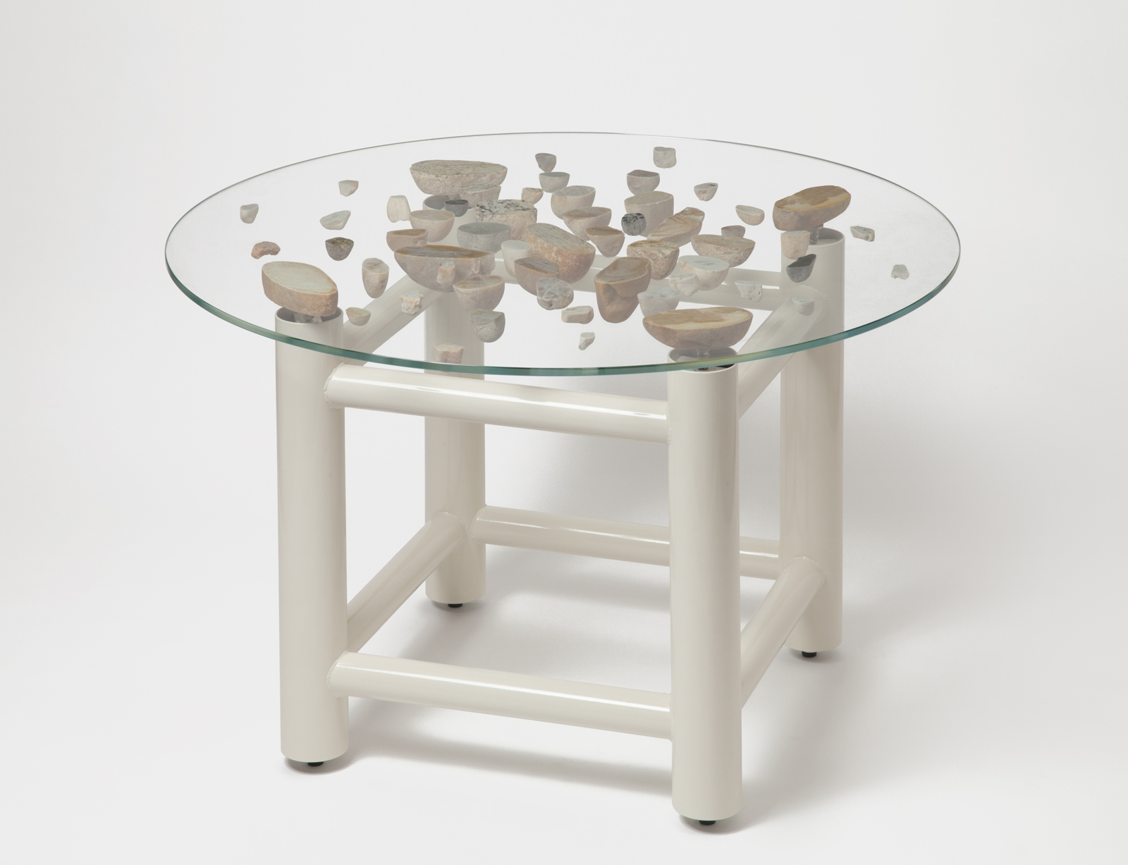 round glass floating stone table with white base.