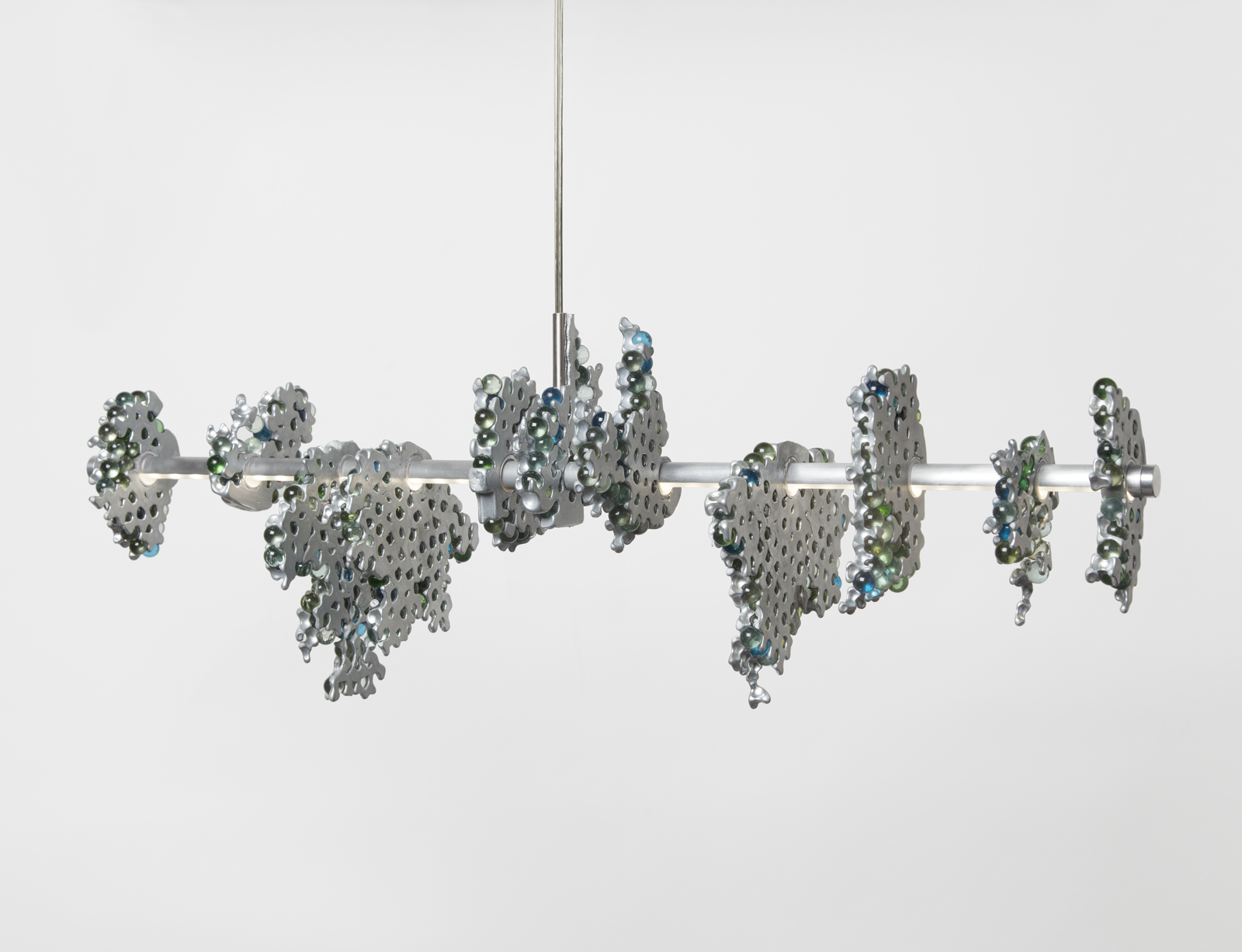 hanging light consisting of a main horizontal LED strip with glass marble clusters held together in aluminum chunks. suspended from ceiling.