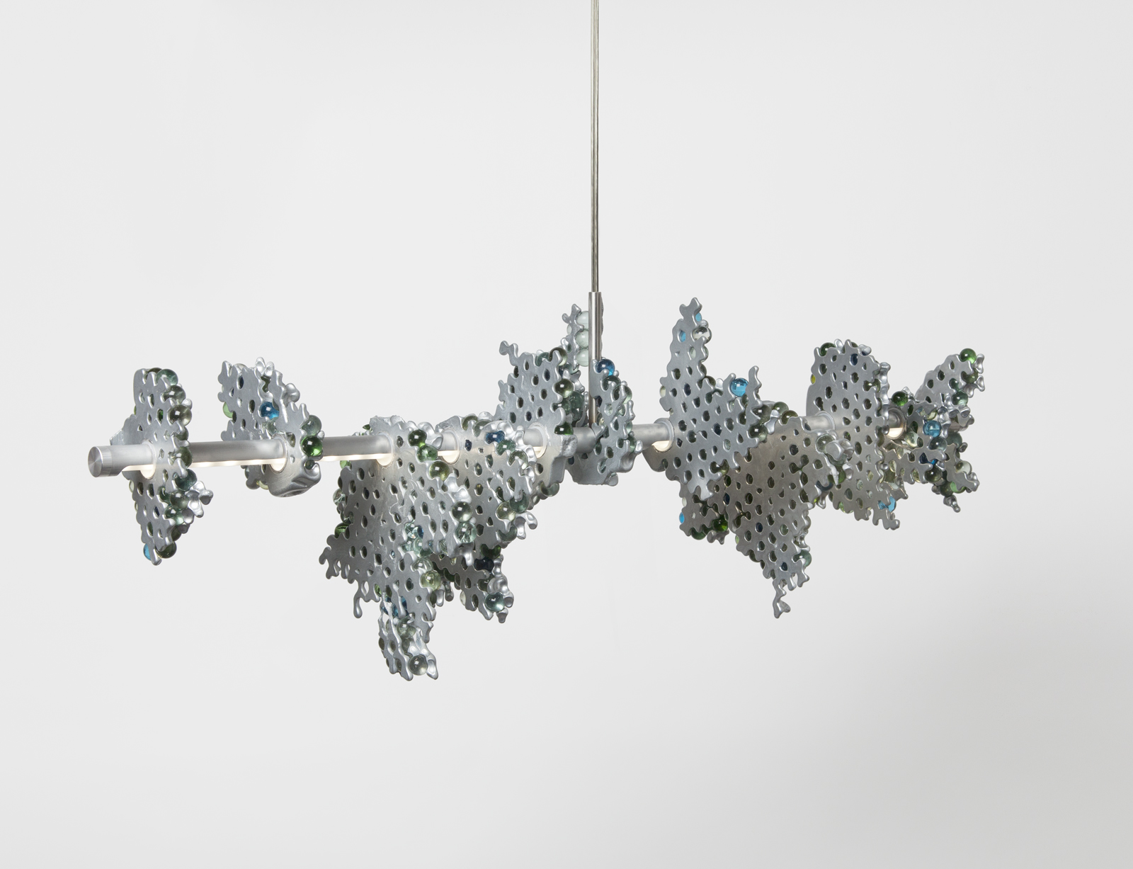 side view of hanging light consisting of a main horizontal LED strip with glass marble clusters held together in aluminum chunks.