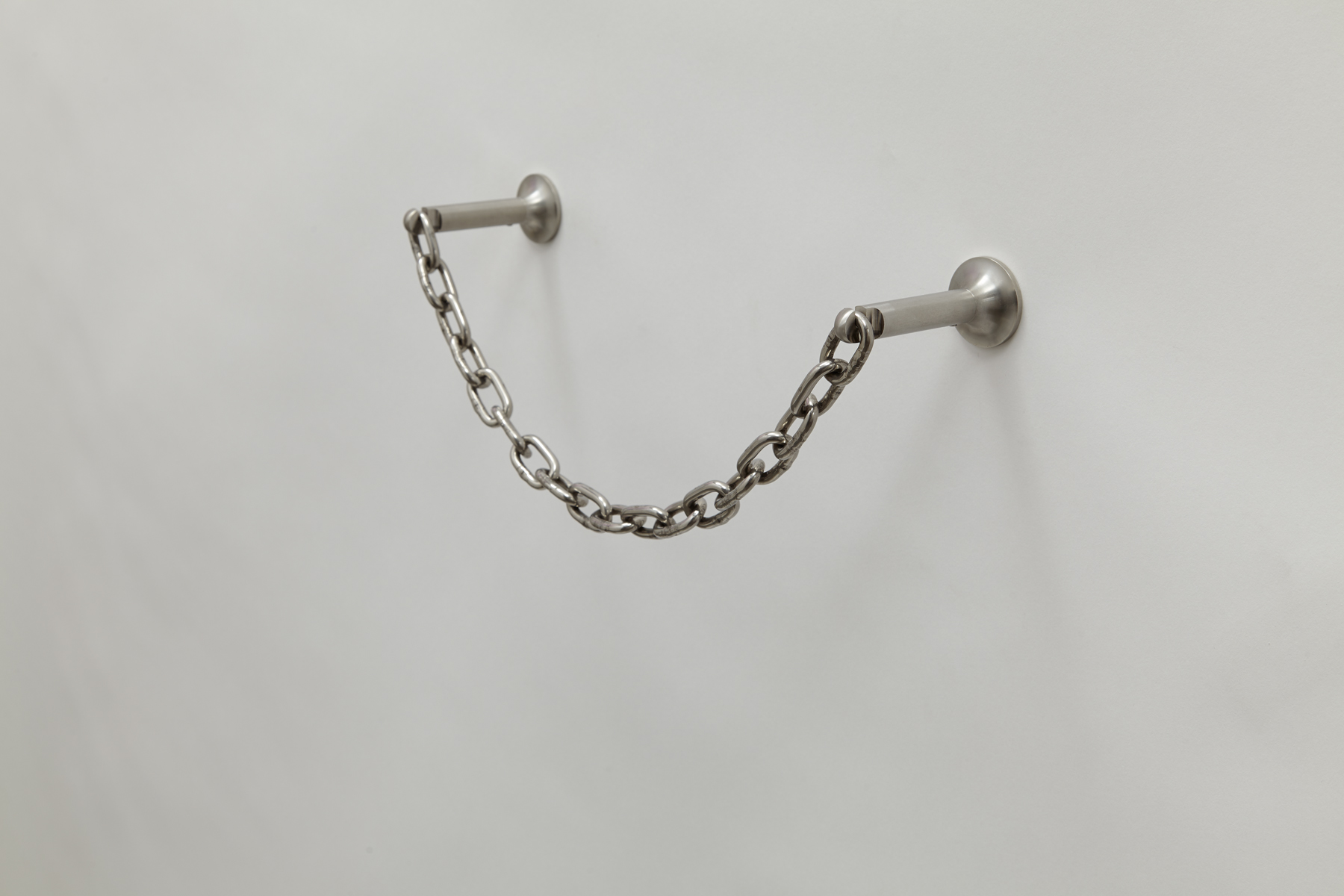 side view of wall mounted paper towel holder made of chain connected by two steel rods