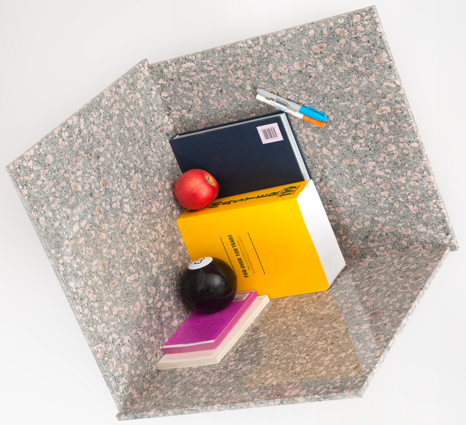 books and other desk objects in a three sided box