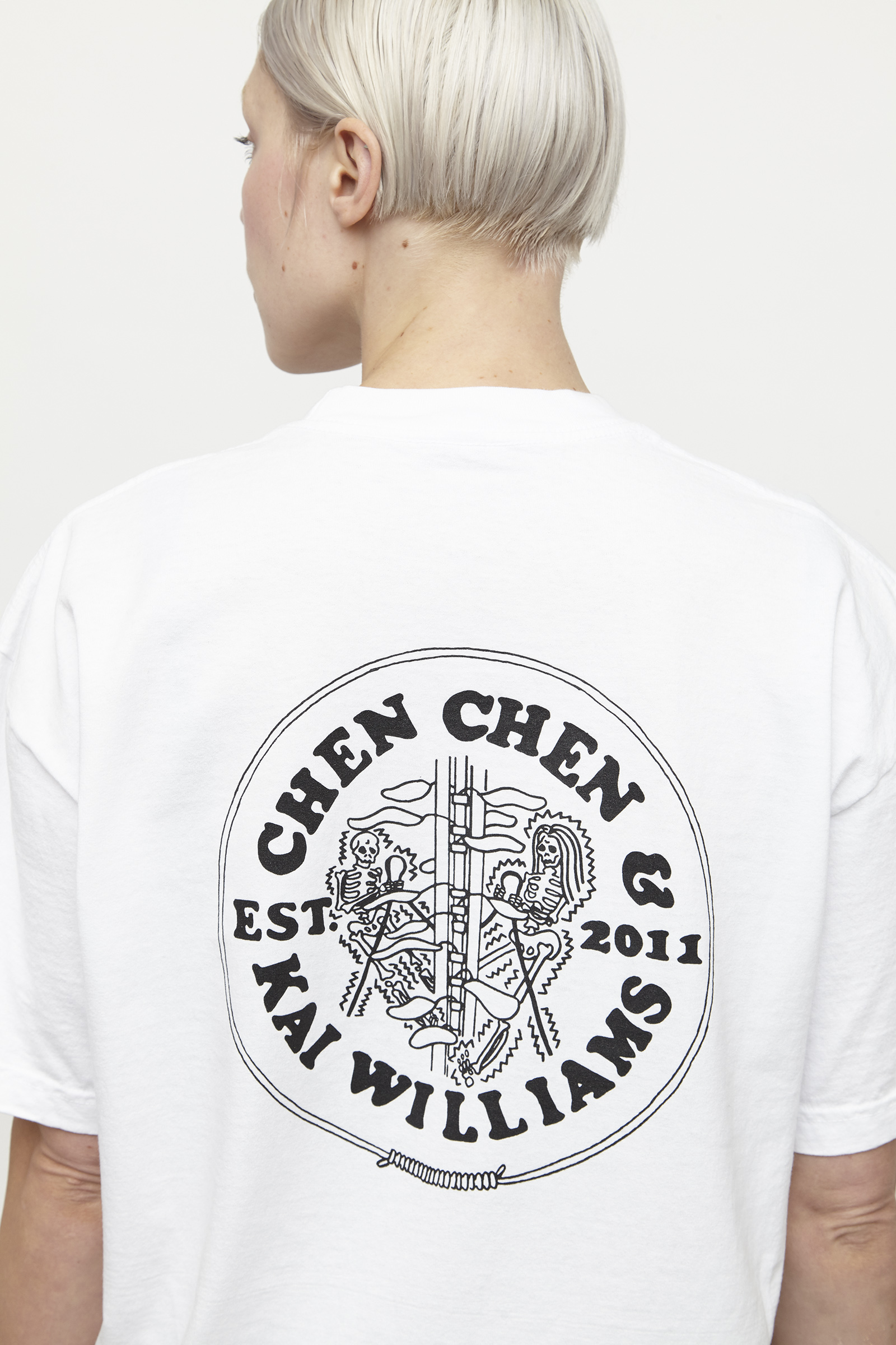 close up of back of white t shirt with black graphics