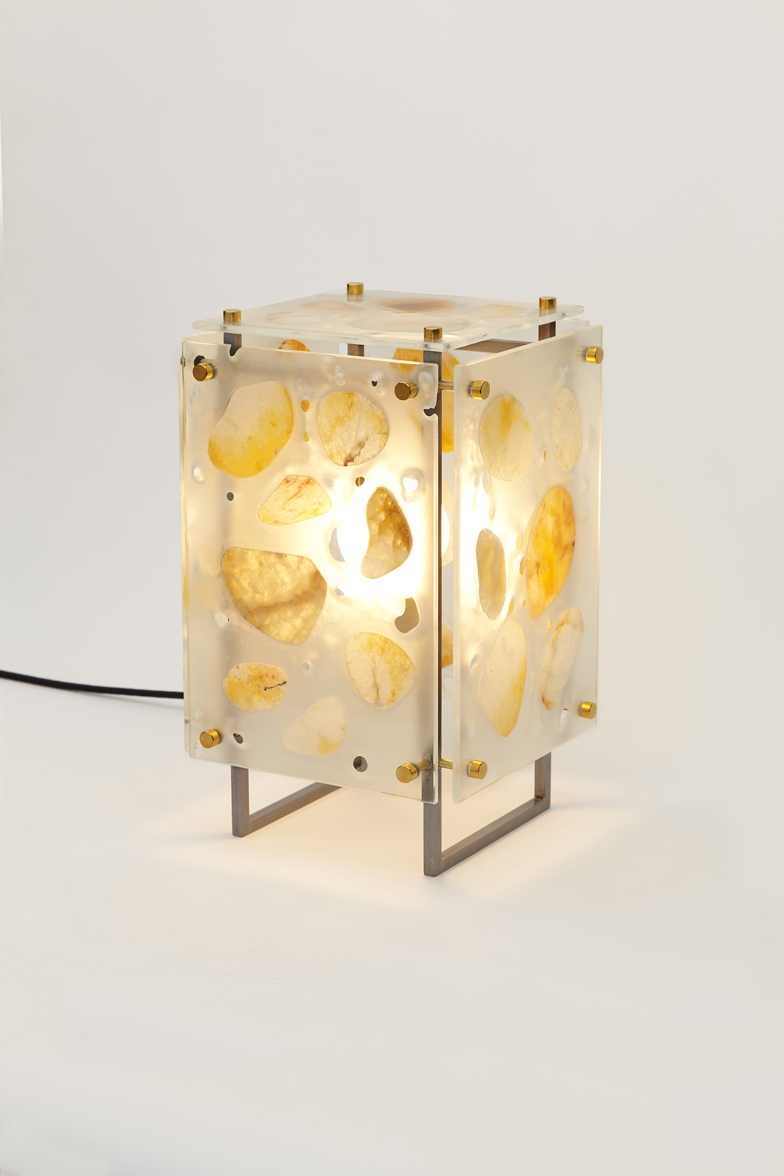 table light made from sandblasted glass panels with stones glued on, hanging off of a metal frame