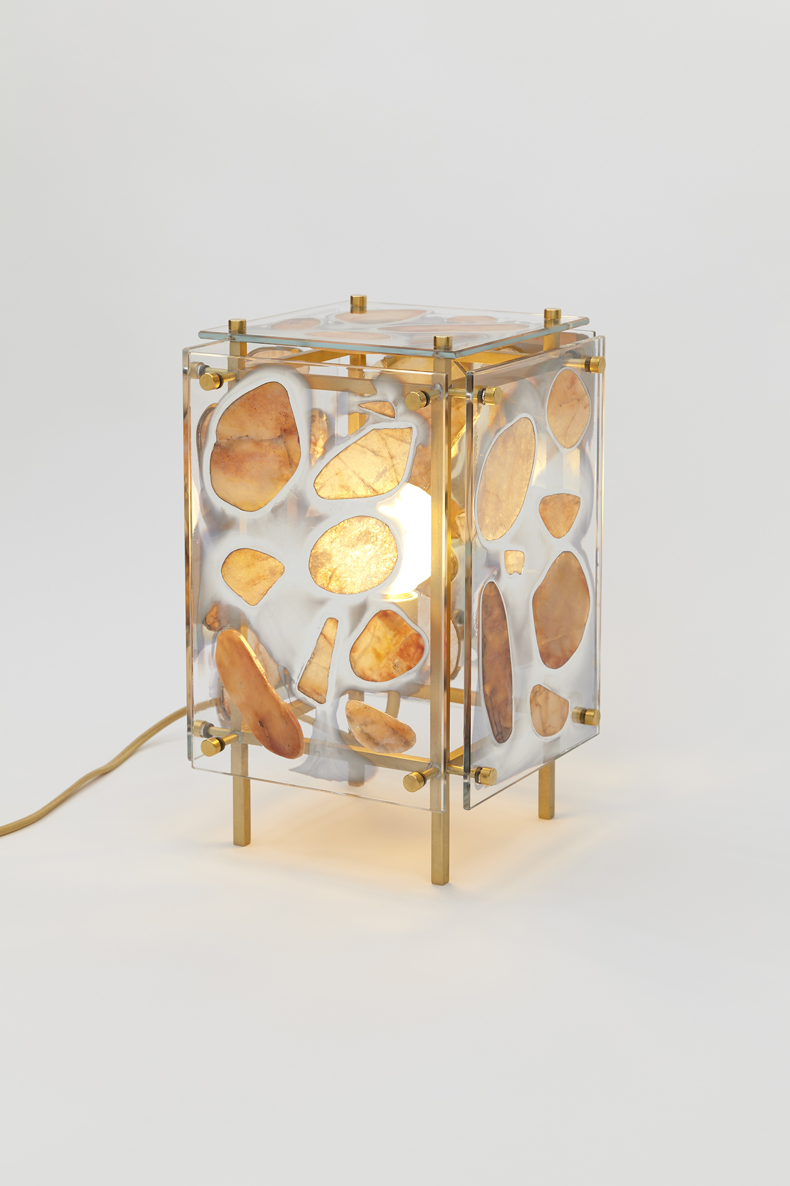 table light made from silvered glass panels with stones glued on, hanging off of a metal frame