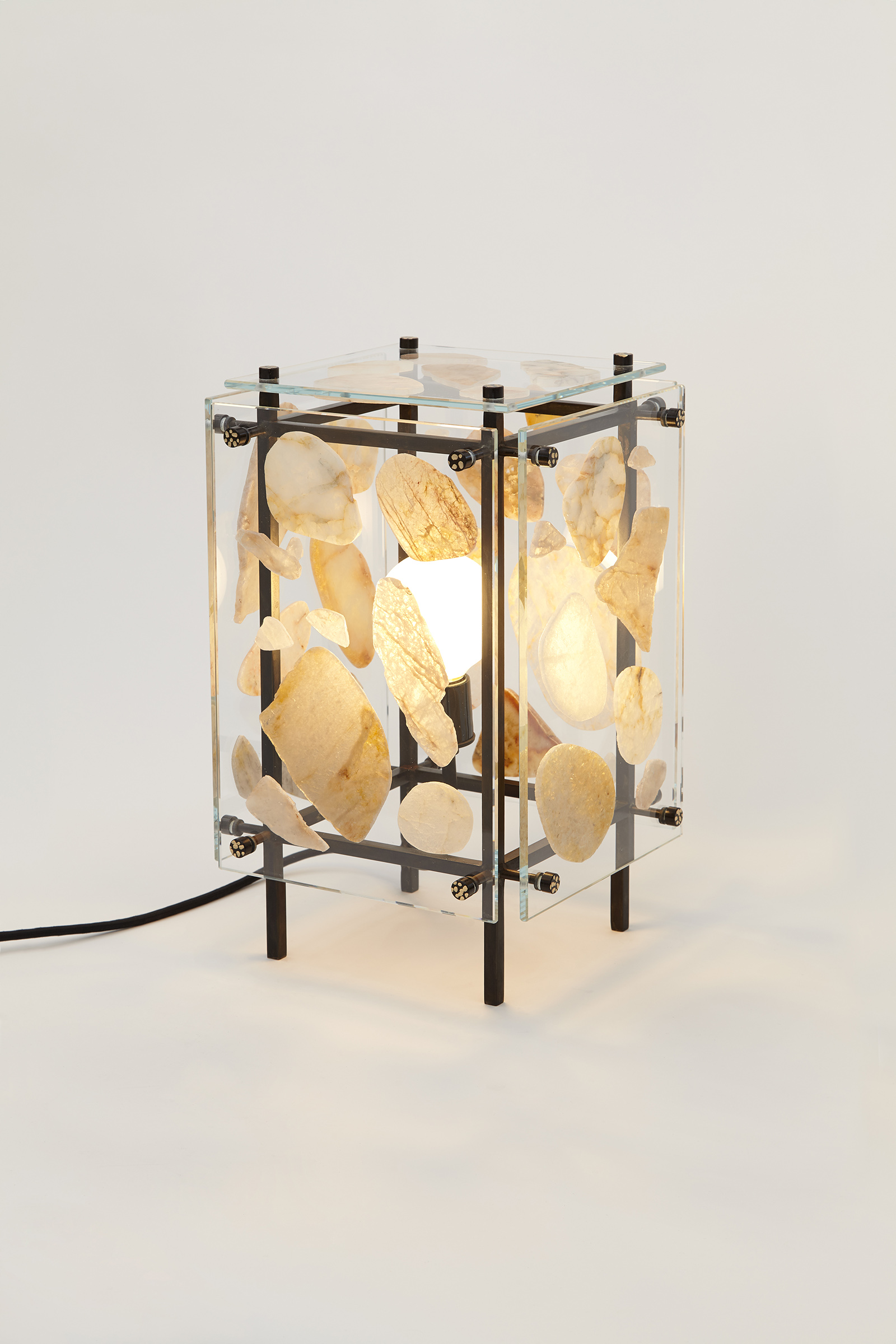 table light made from clear glass panels with stones glued on, hanging off of a metal frame