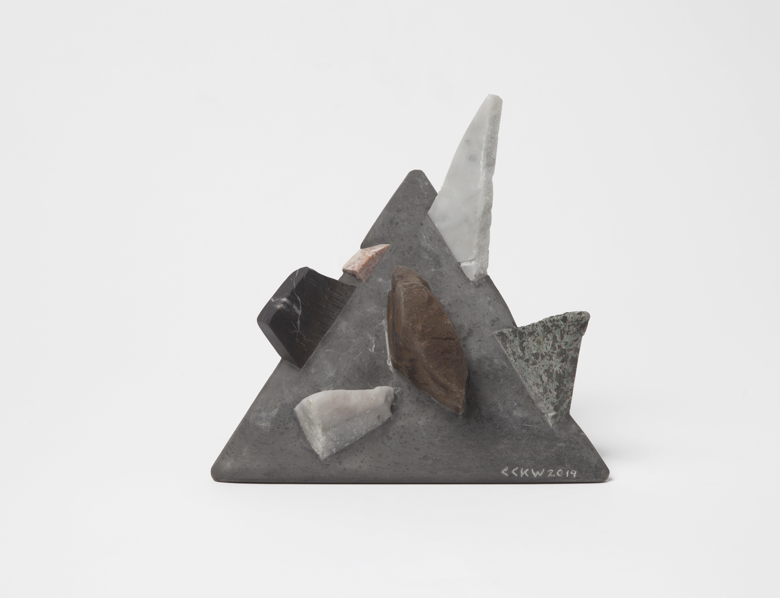 triangular bookend with rough rock chunks sticking out.