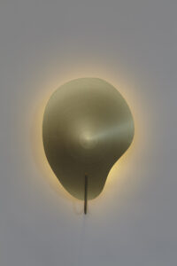 front view of gold color petal shaped wall mounted sconce.