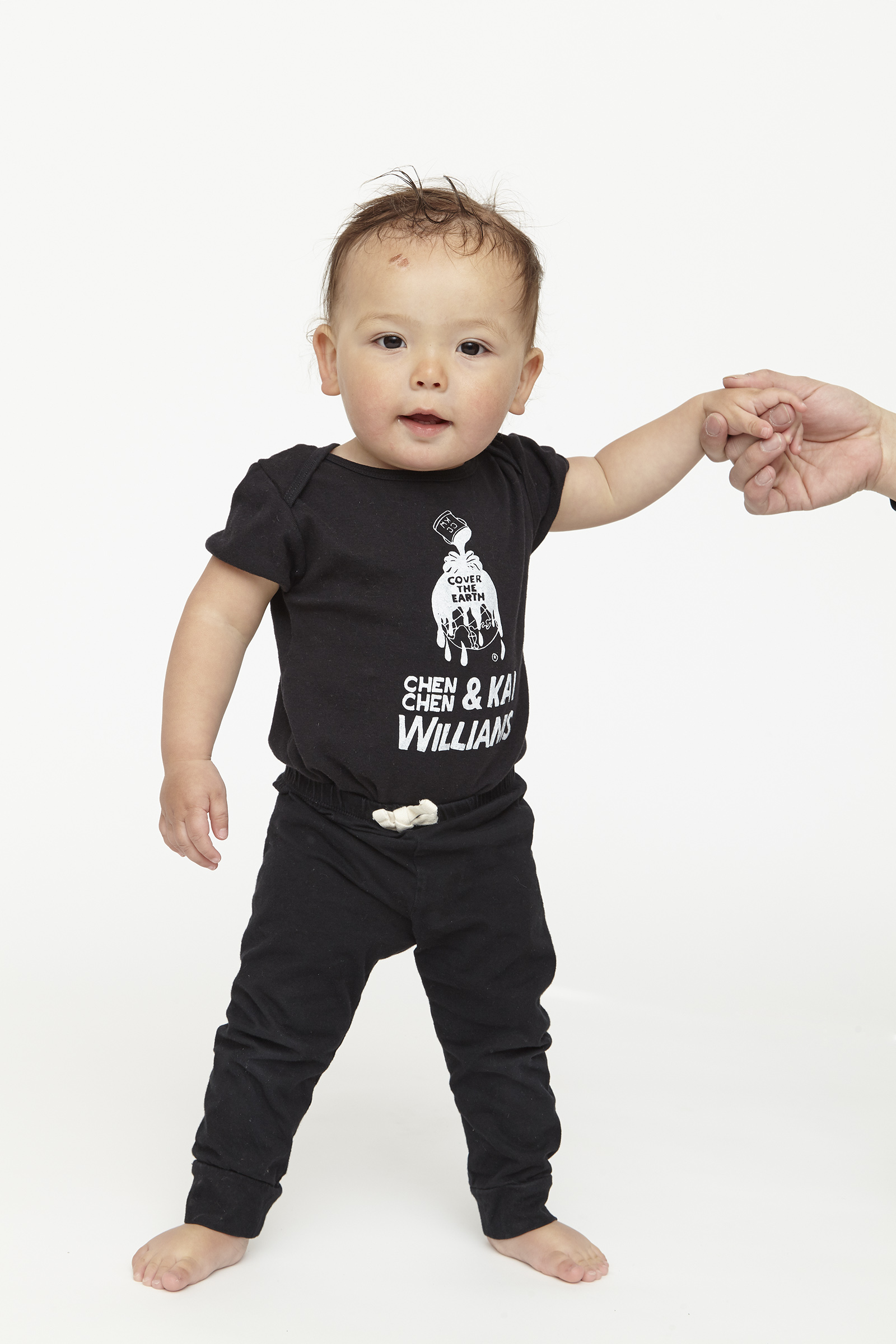 child wearing black onesie with white graphics