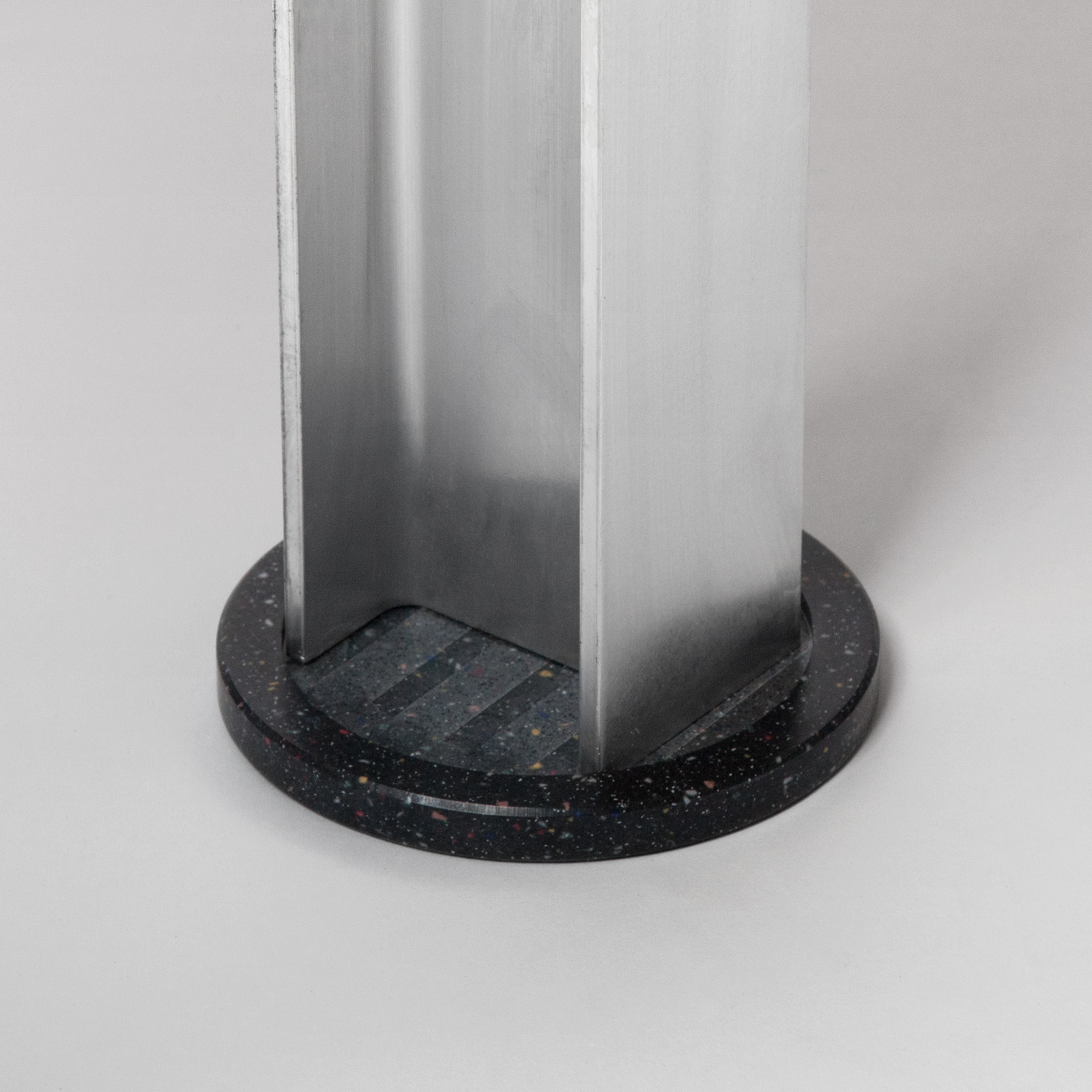 close up of aluminum table leg and base.