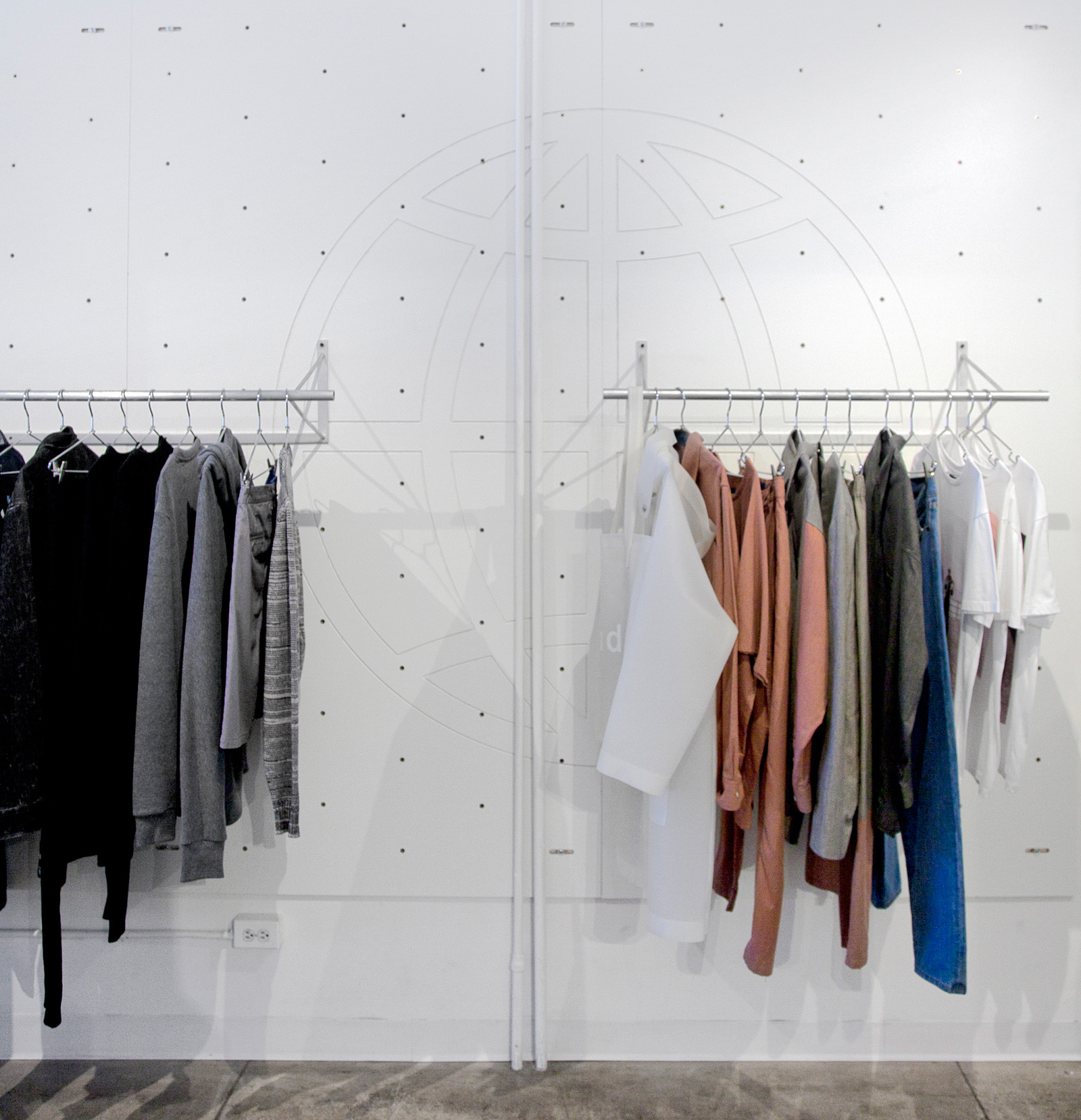 clothing racks in a white room.