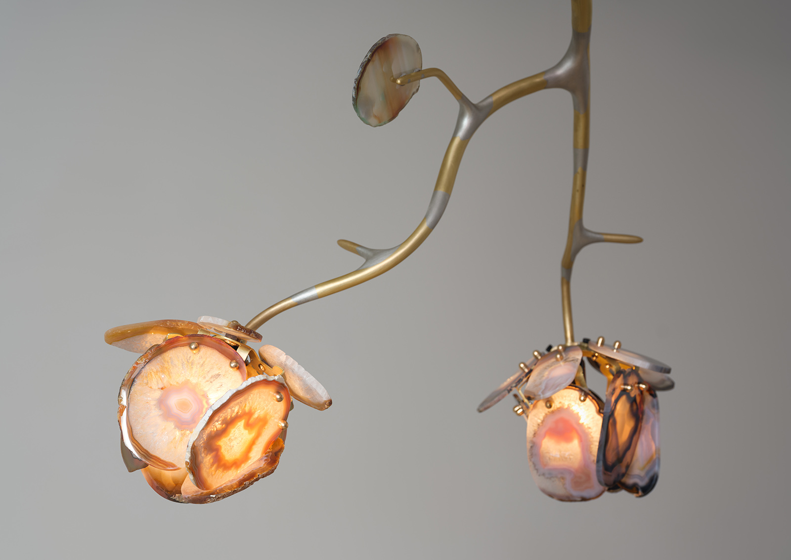close up of illuminated agate flowers on an organic brass structure