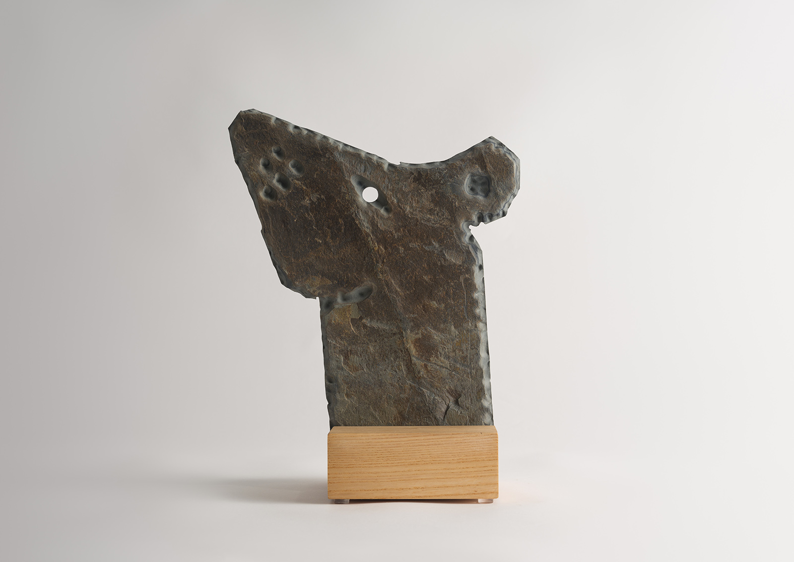 stone rat carved from slate on a wood base