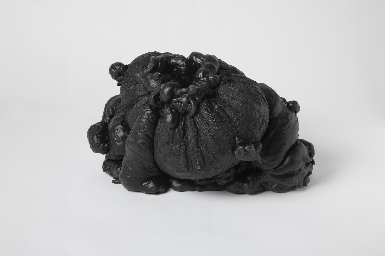 vase made of expanding foam coming out of spandex netting coated in black rubber
