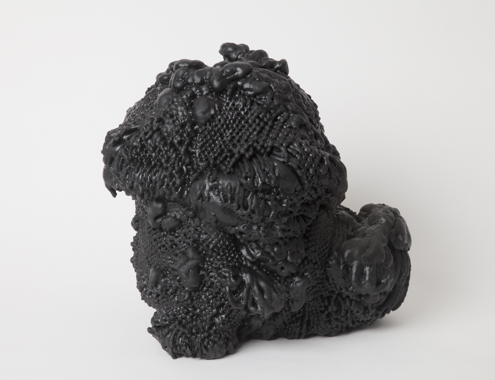 vase made of expanding foam coming out of spandex netting coated in black rubber