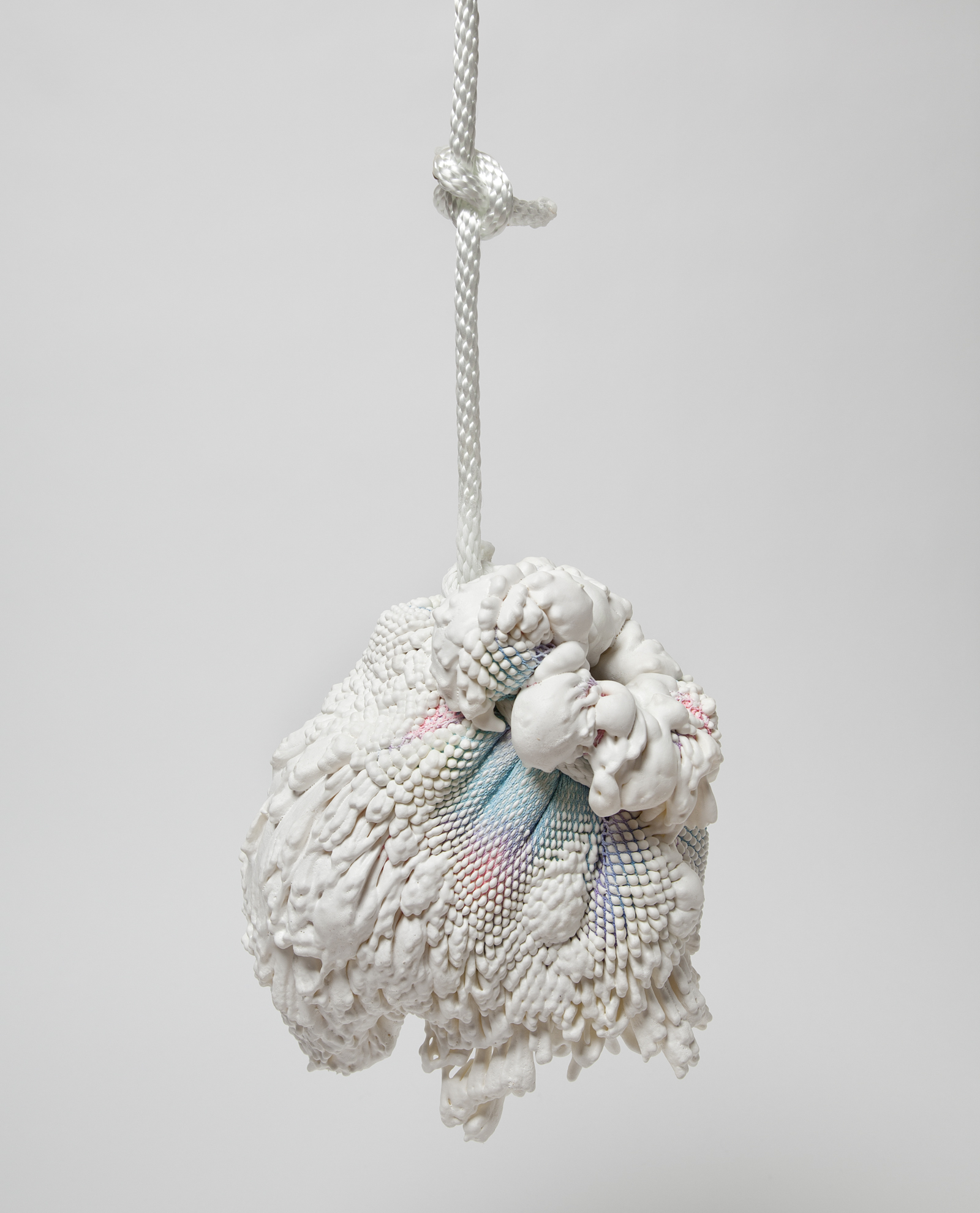 a vase made from gradient spandex with expanding foam extruding out of it