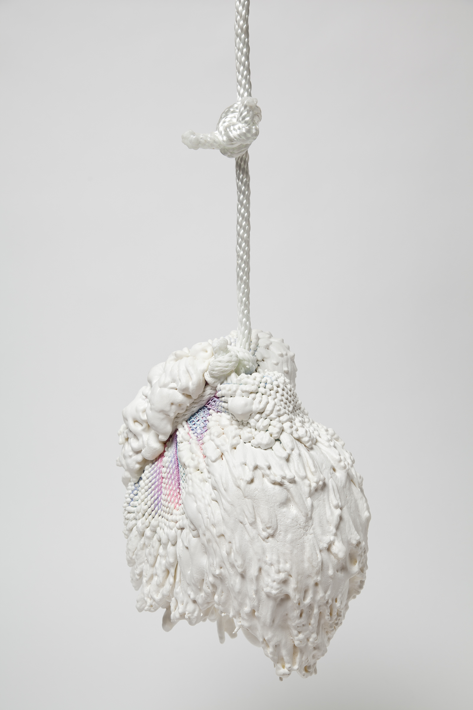 a vase made from gradient spandex with expanding foam extruding out of it