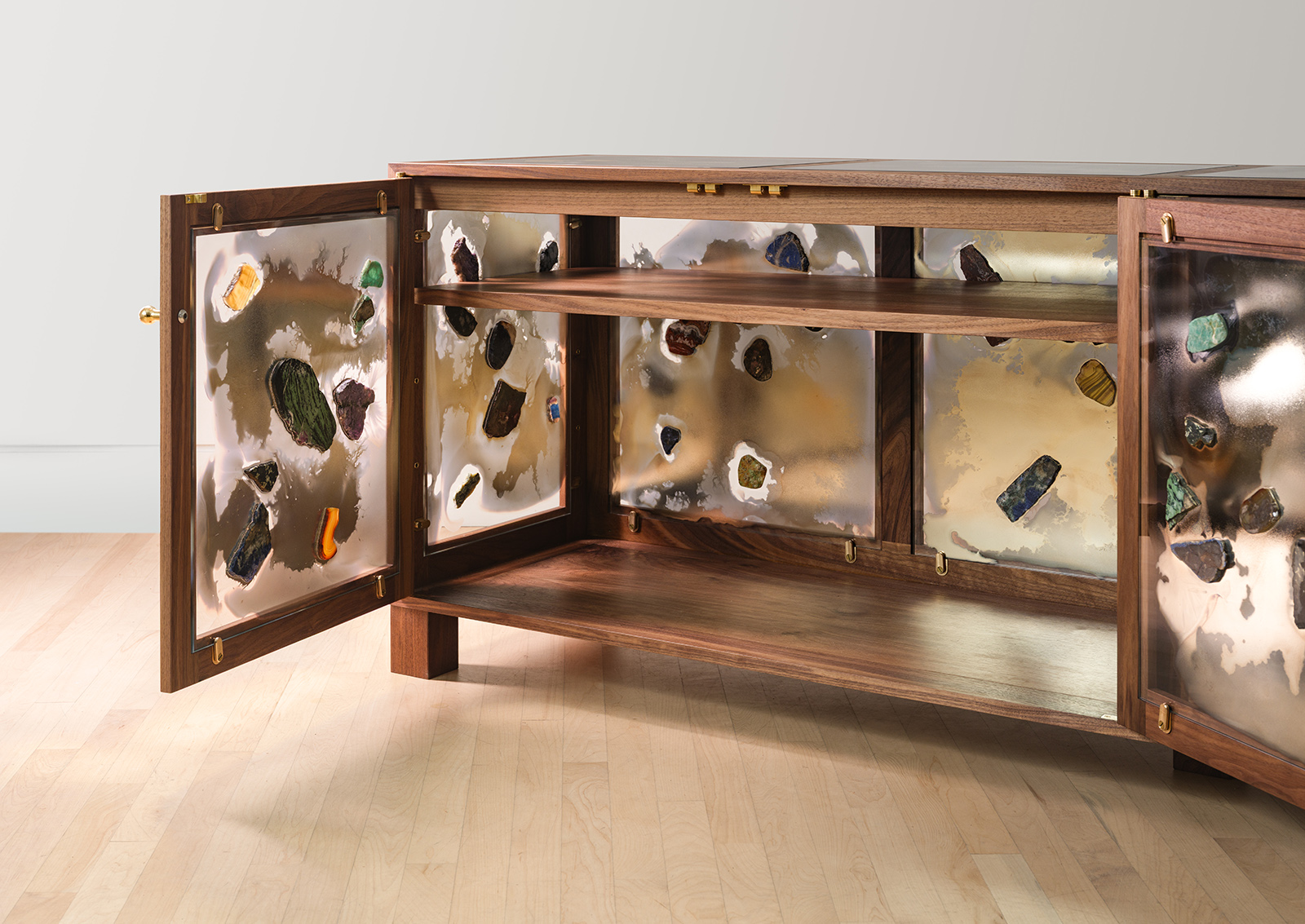 Walnut wood frame credenza with sides made from mirrored glass with stones glued on with door open, looking inside
