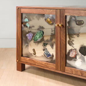 detail of walnut frame cabinet with mirrored glass panels with stones glued on