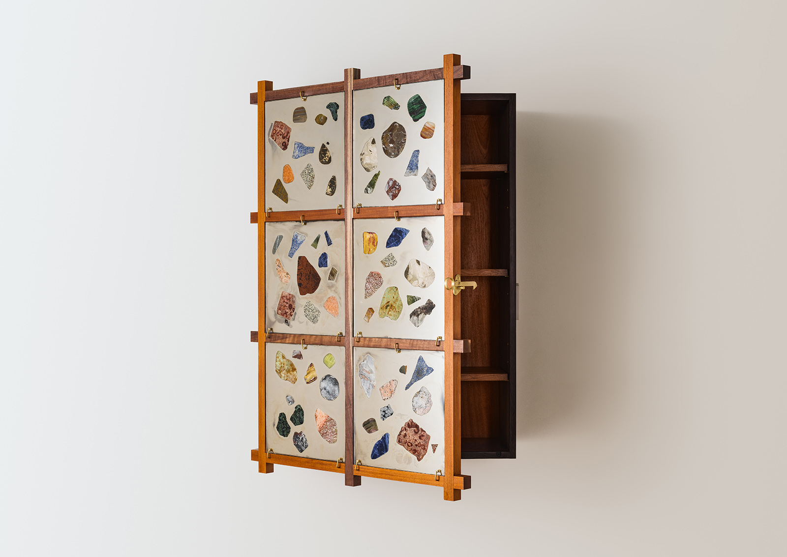 walnut and mahogany wall cabinet with mirrored glass panels with stones glued on, door is slightly open