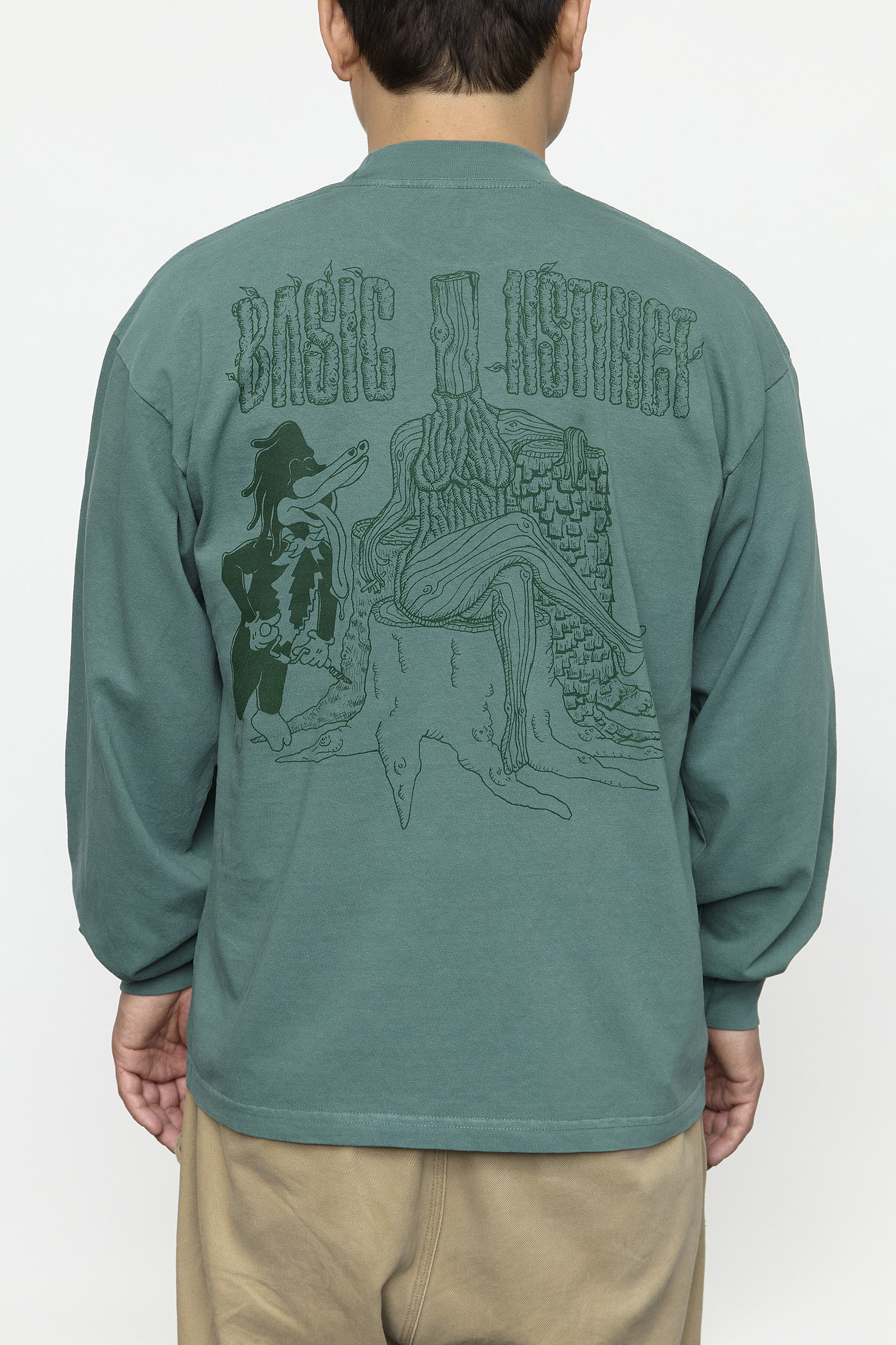 man wearing a green long sleeve graphic shirt, back facing forward