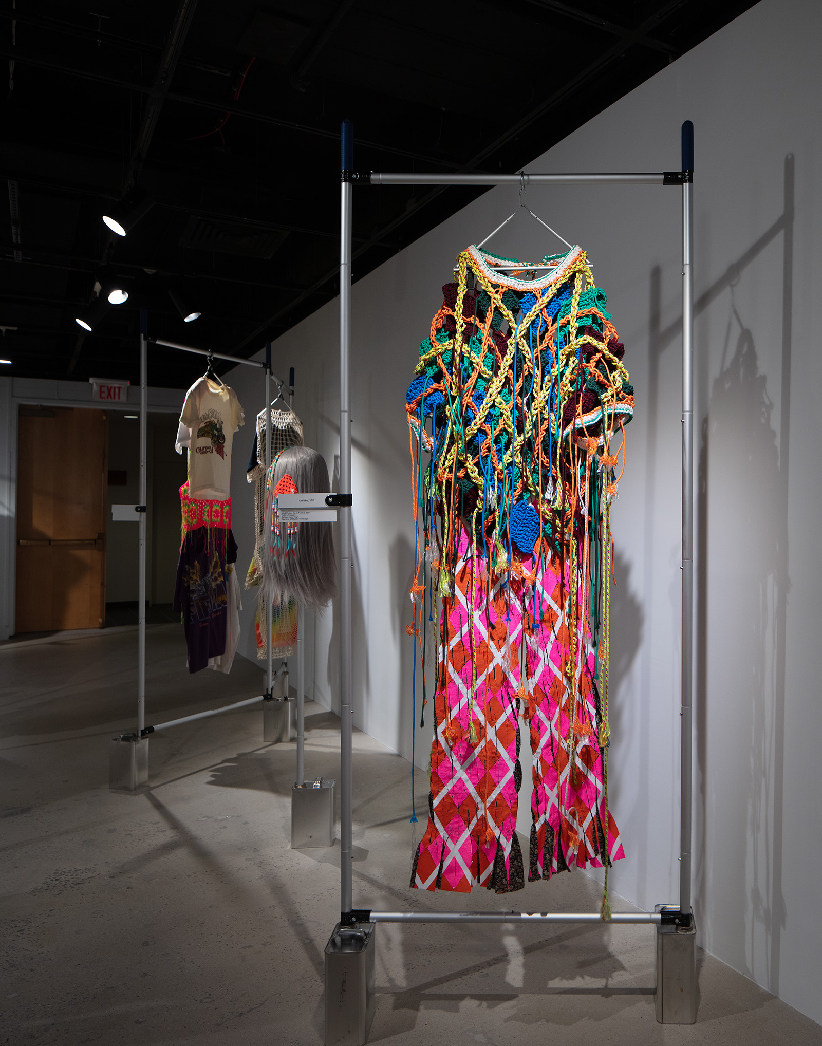 colorful clothing hanging on a bar apparatus