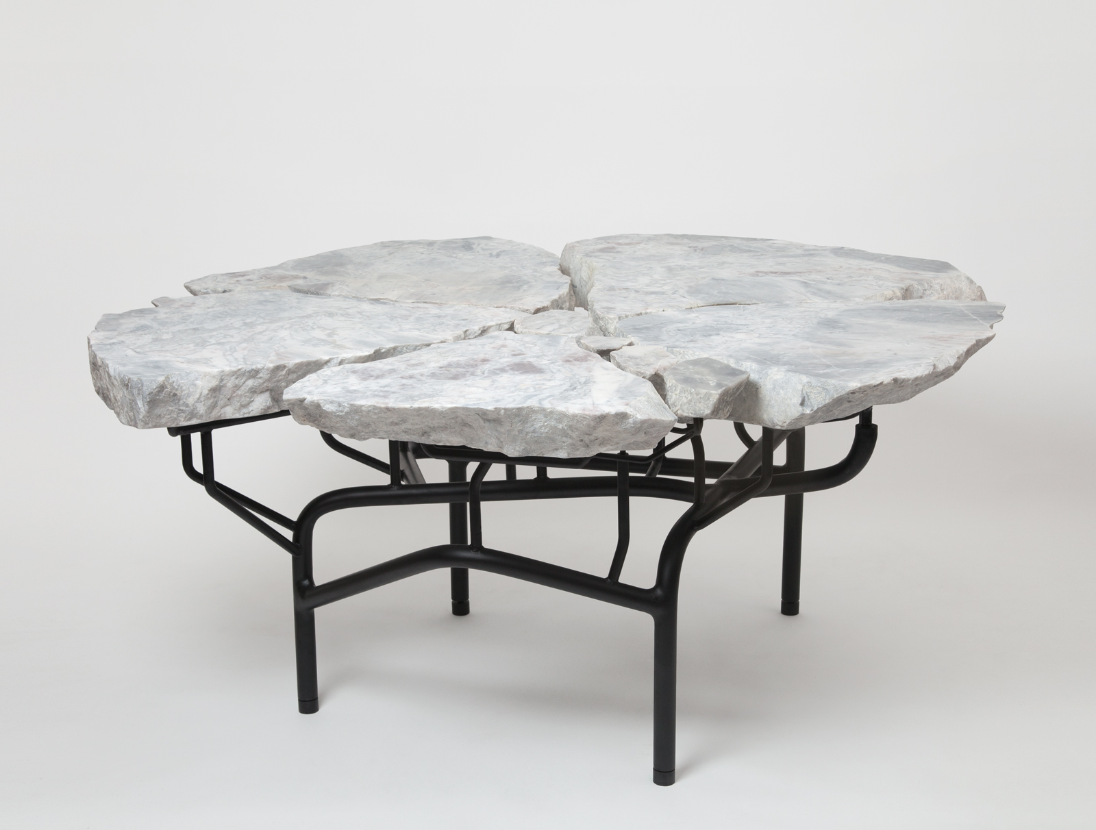 dining table made from slabs of stone with a black metal legs