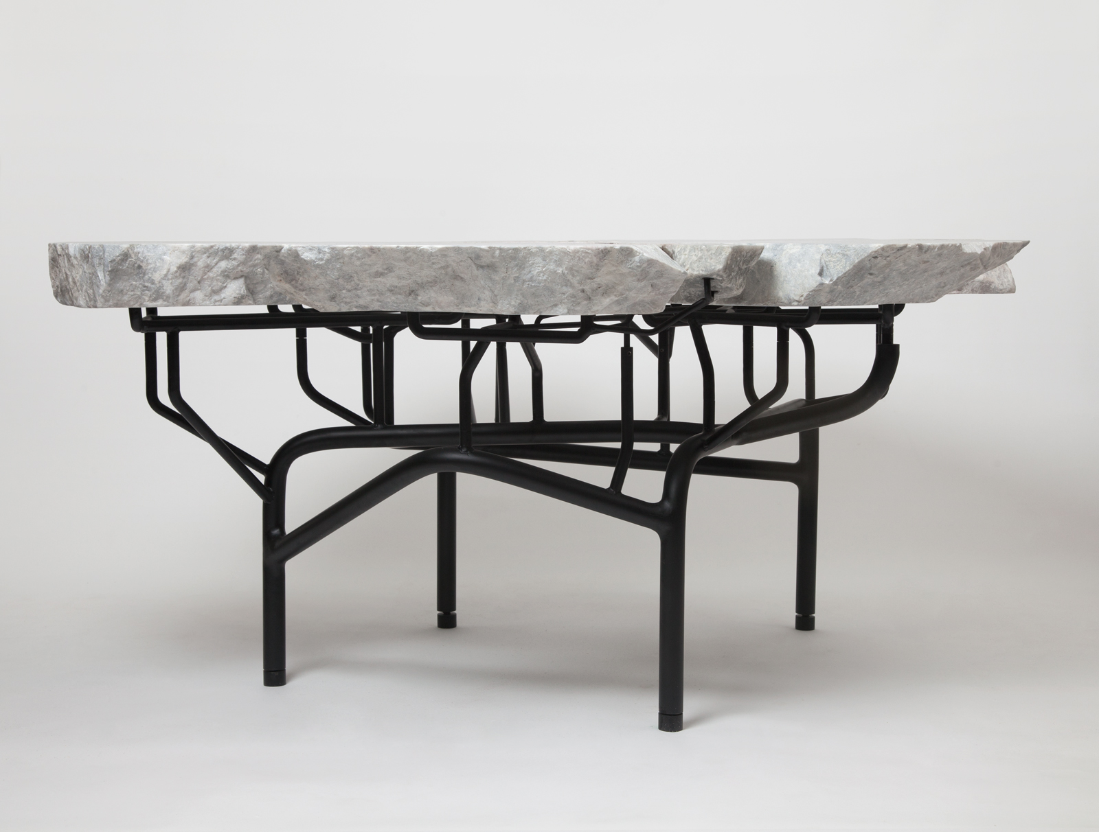 dining table made from slabs of stone with a black metal legs