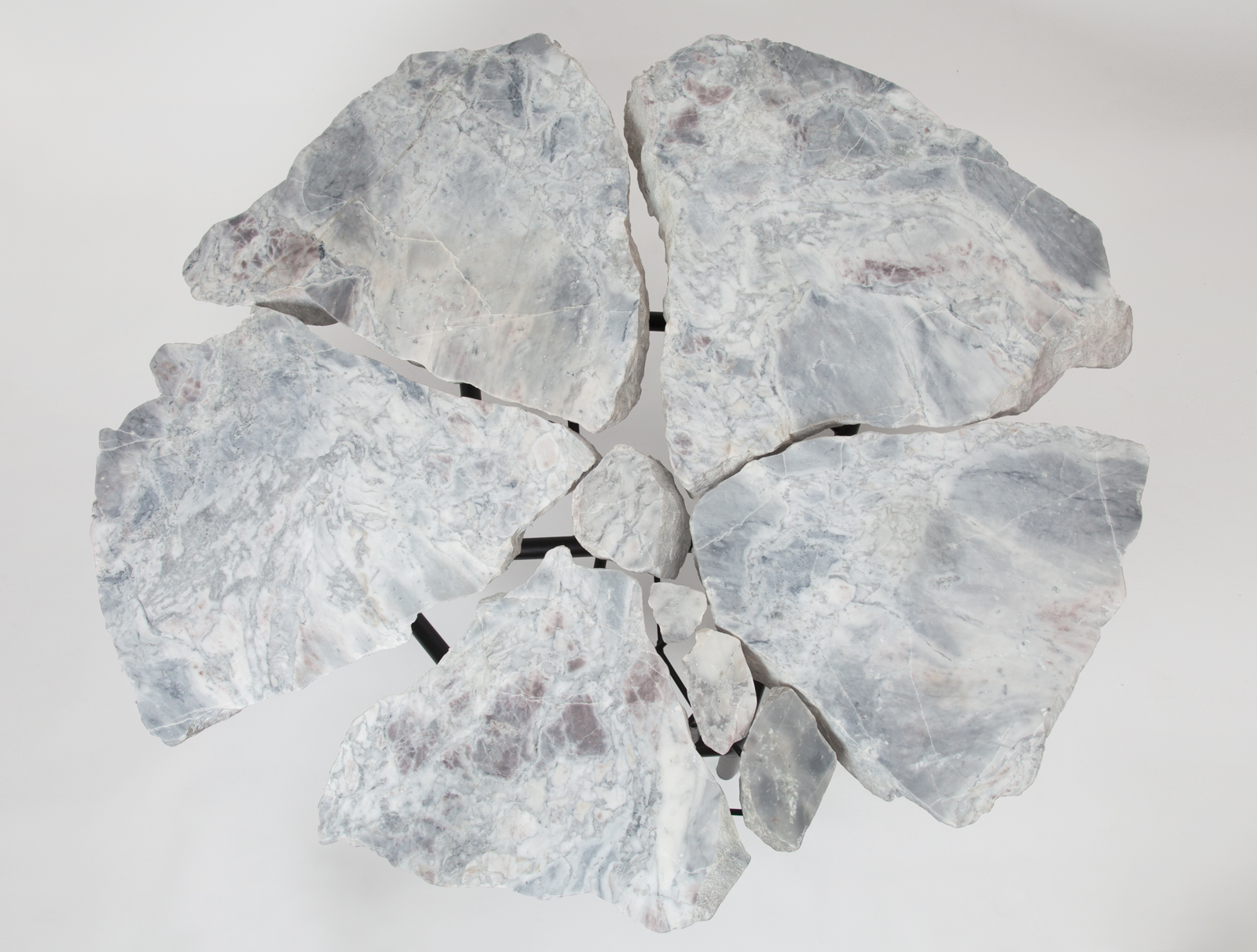 dining table made from slabs of stone with a black metal legs